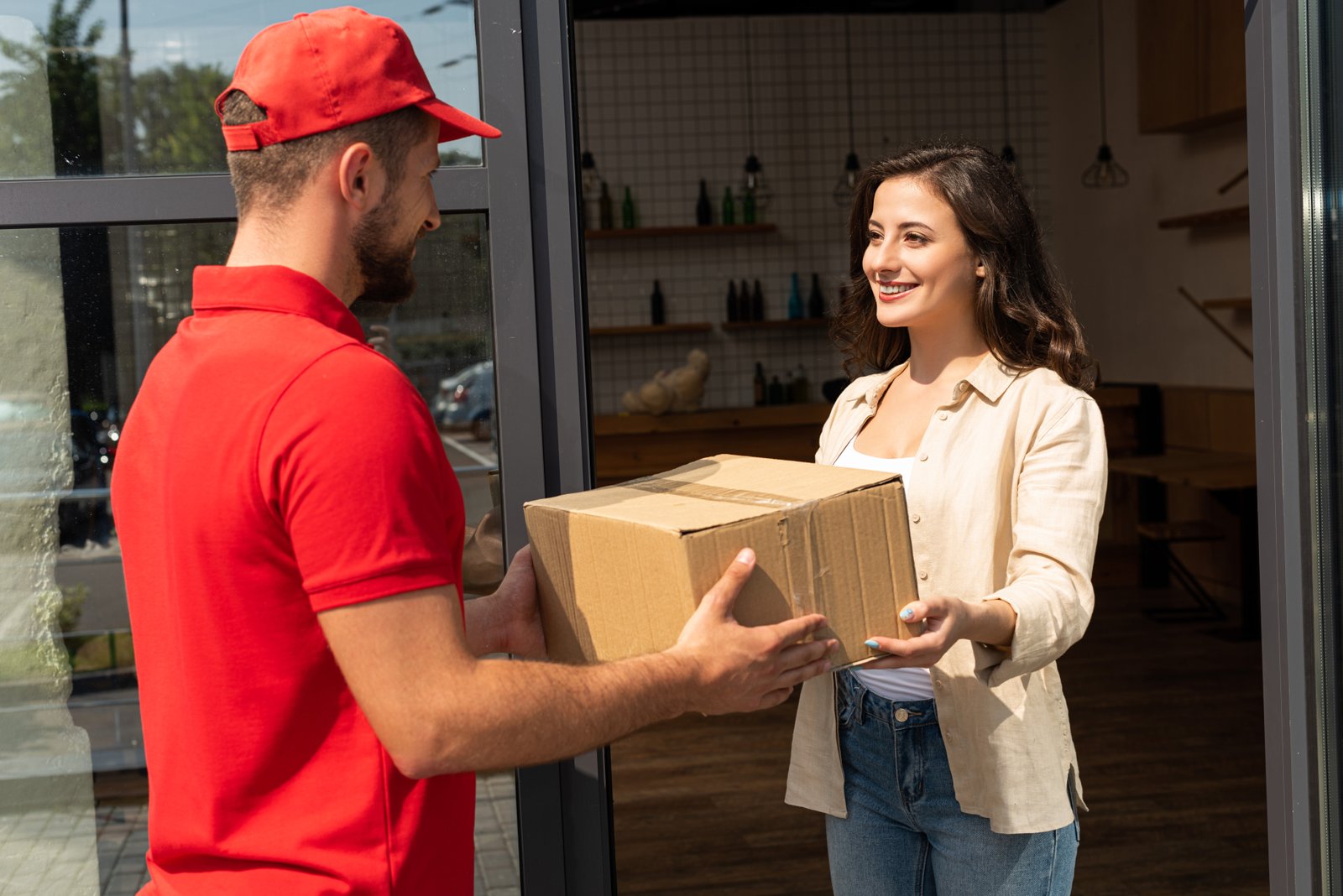 bearded delivery man giving cardboard box to cheer 2023 11 27 05 04 34 utc