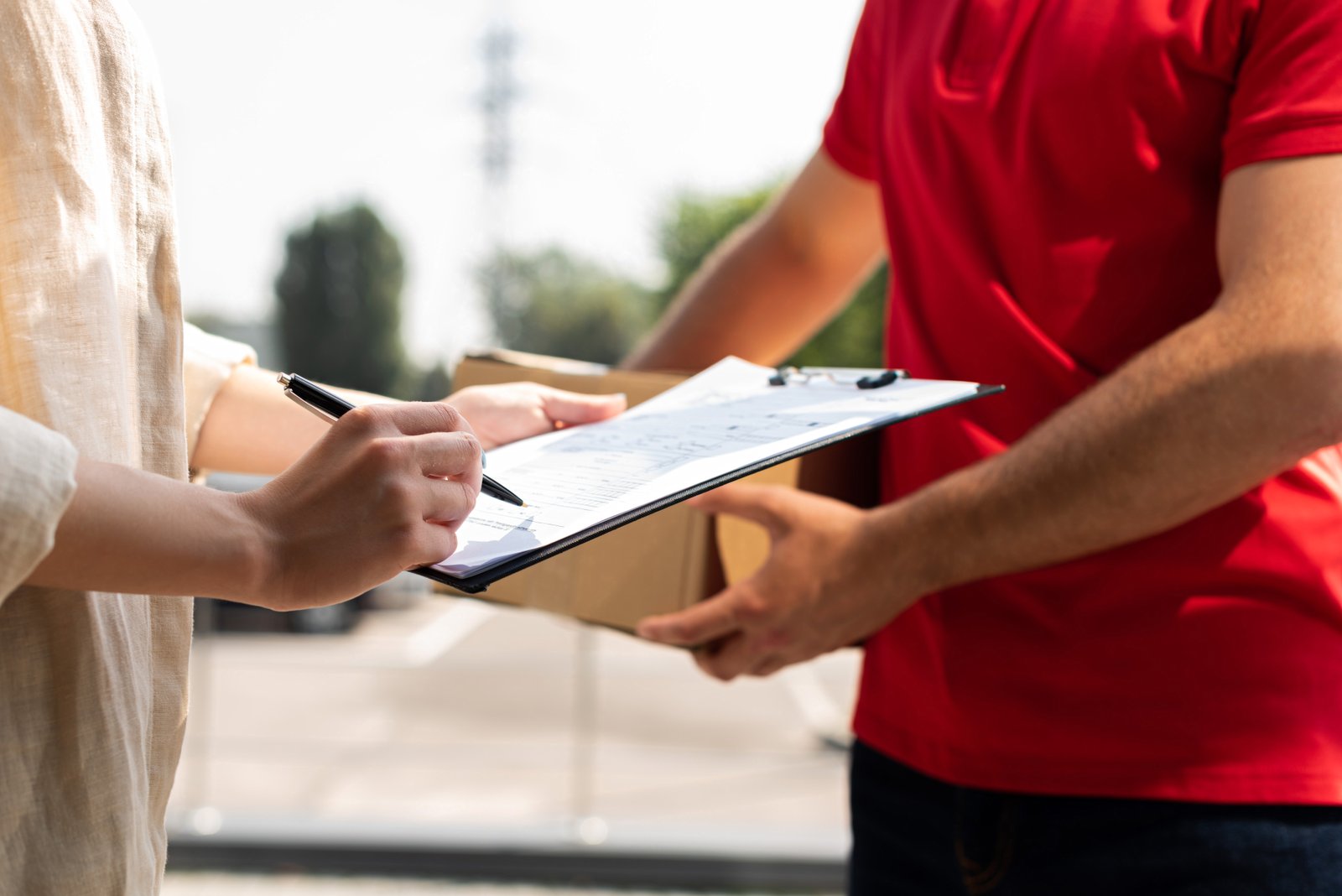 cropped view of delivery man holding clipboard whi 2023 11 27 05 26 06 utc